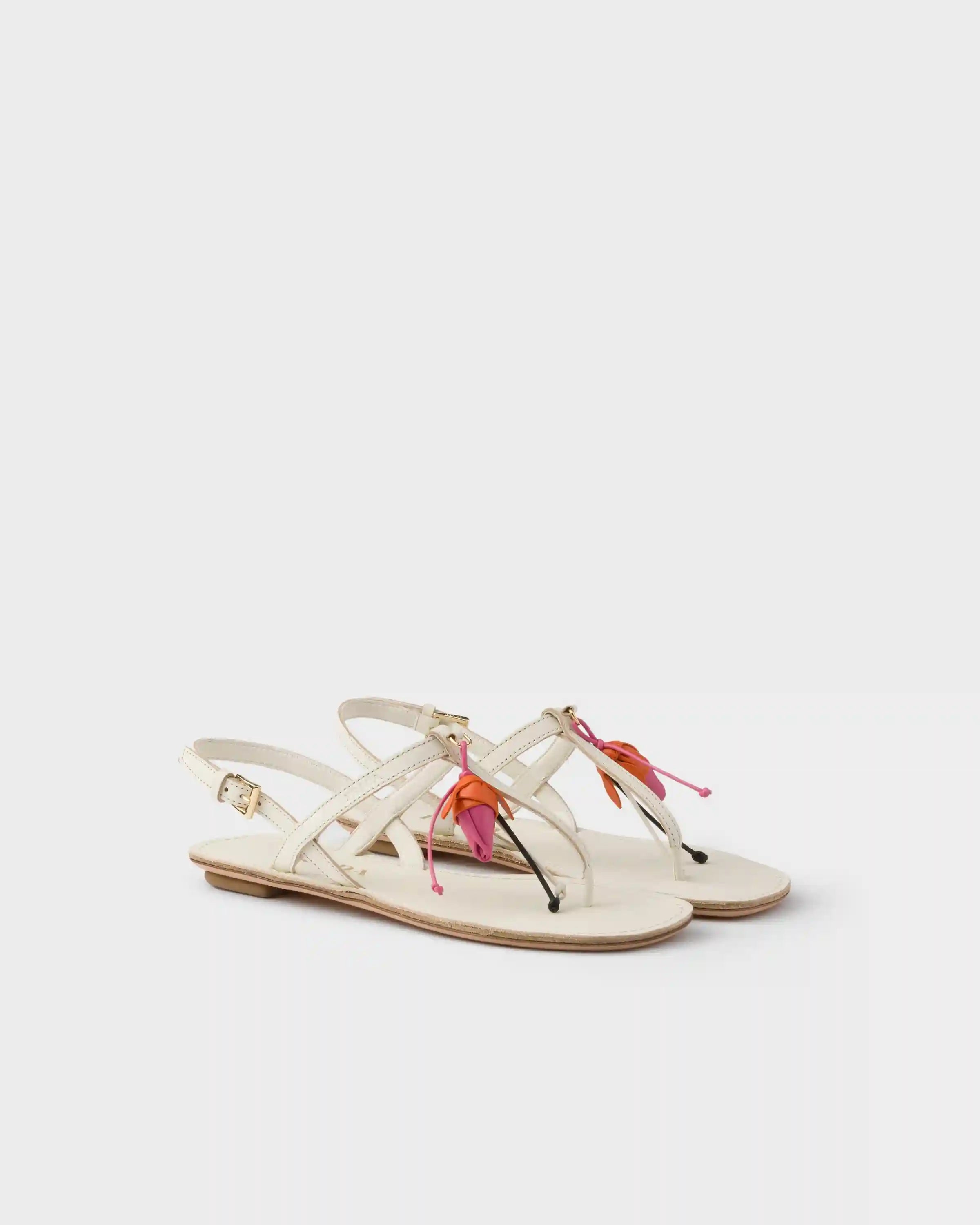 Antiqued leather thong sandals with floral ornament