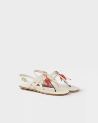 Antiqued leather thong sandals with floral ornament