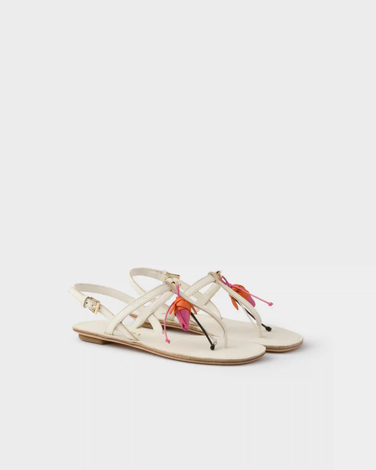 Antiqued leather thong sandals with floral ornament